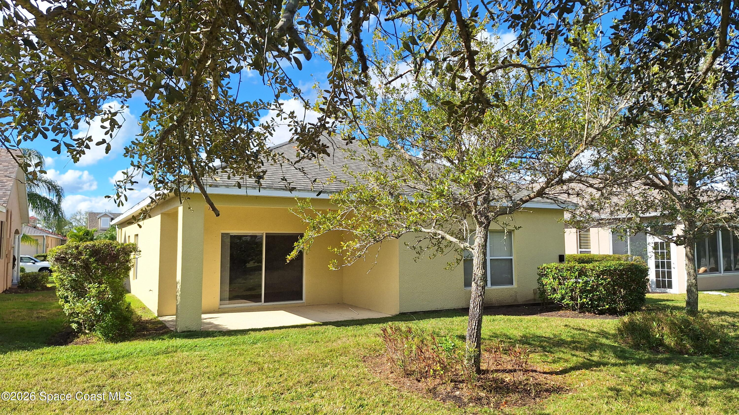 6921 Abbeyville Road Melbourne, FL 32940 - Photo 22 of 24 a front view of a house with a yard