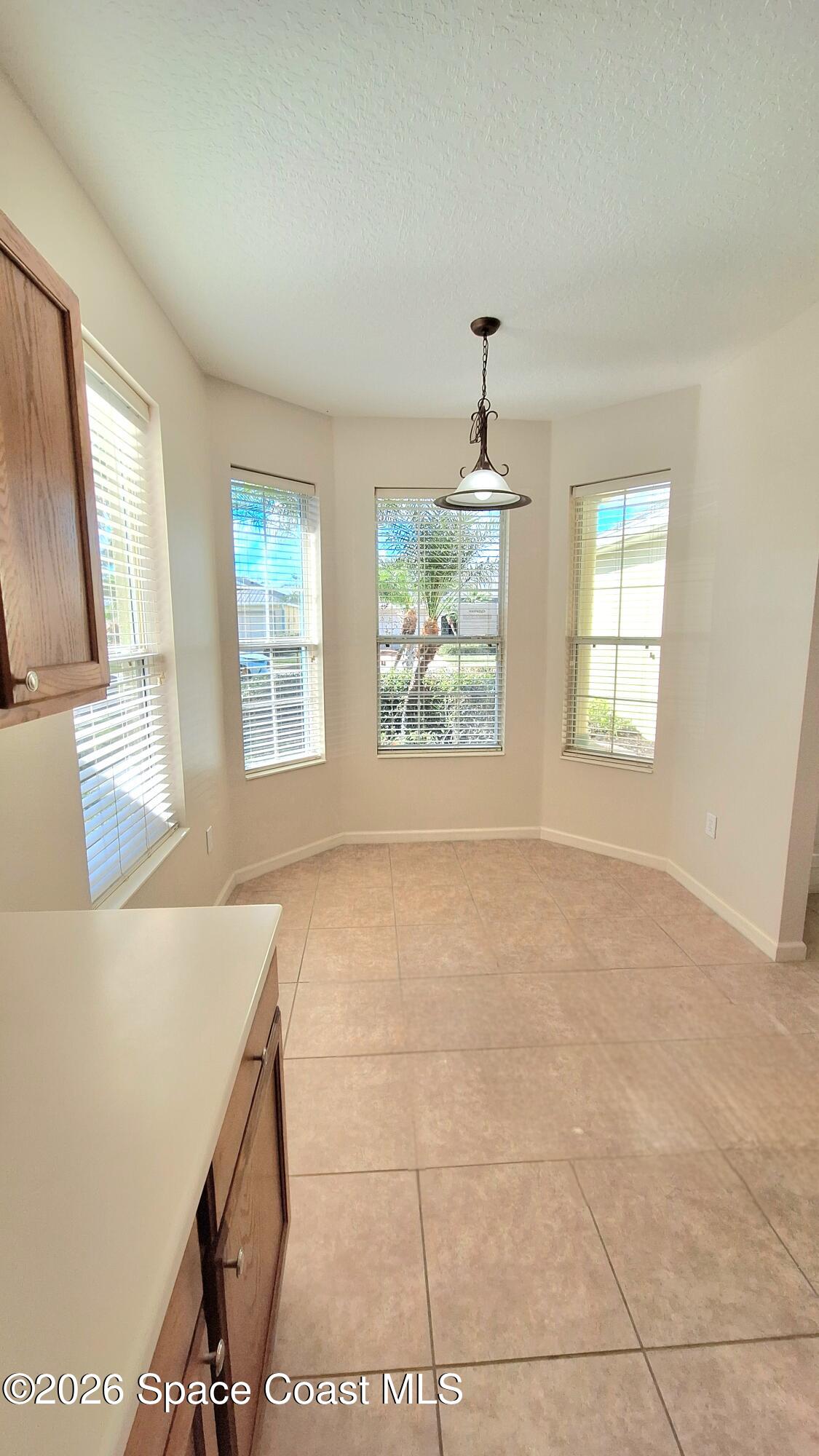 6921 Abbeyville Road Melbourne, FL 32940 - Photo 7 of 24 a view of an empty room with a window
