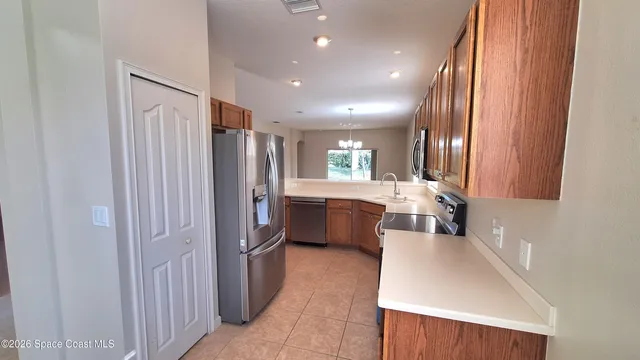 a kitchen with refrigerator a sink and cabinets