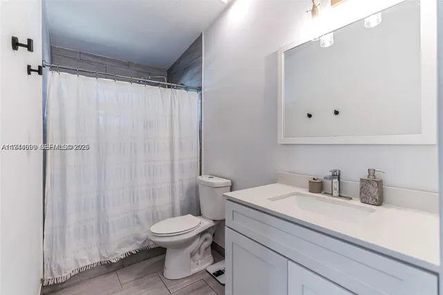 a bathroom with a toilet a sink and a shower