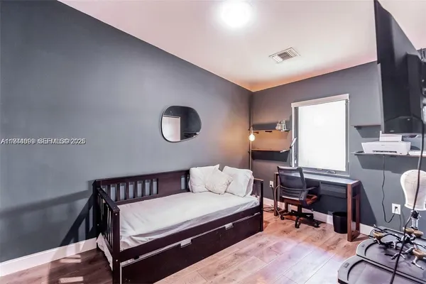 a bedroom with furniture and a window