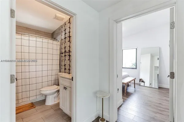 a bathroom with a toilet and a shower
