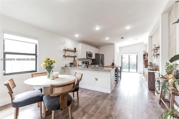 a kitchen with a table and chairs in it