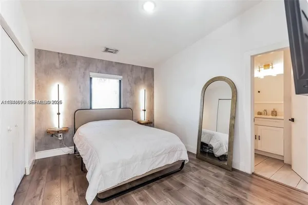 a bedroom with a bed and a potted plant