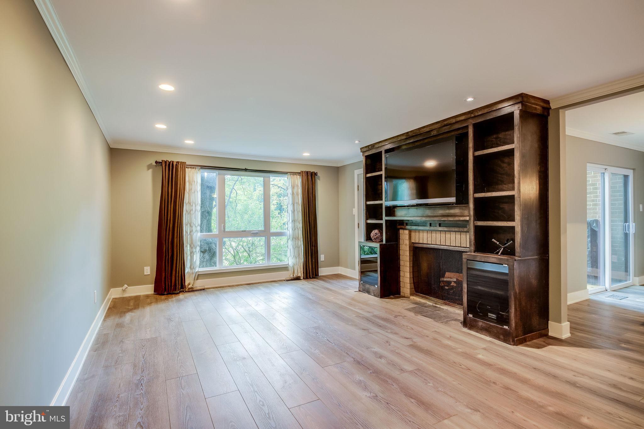 11629 Hunters Green Court Reston, VA 20191 - Photo 8 of 50 Living rm w/ wood burning FP and built-ins + TV