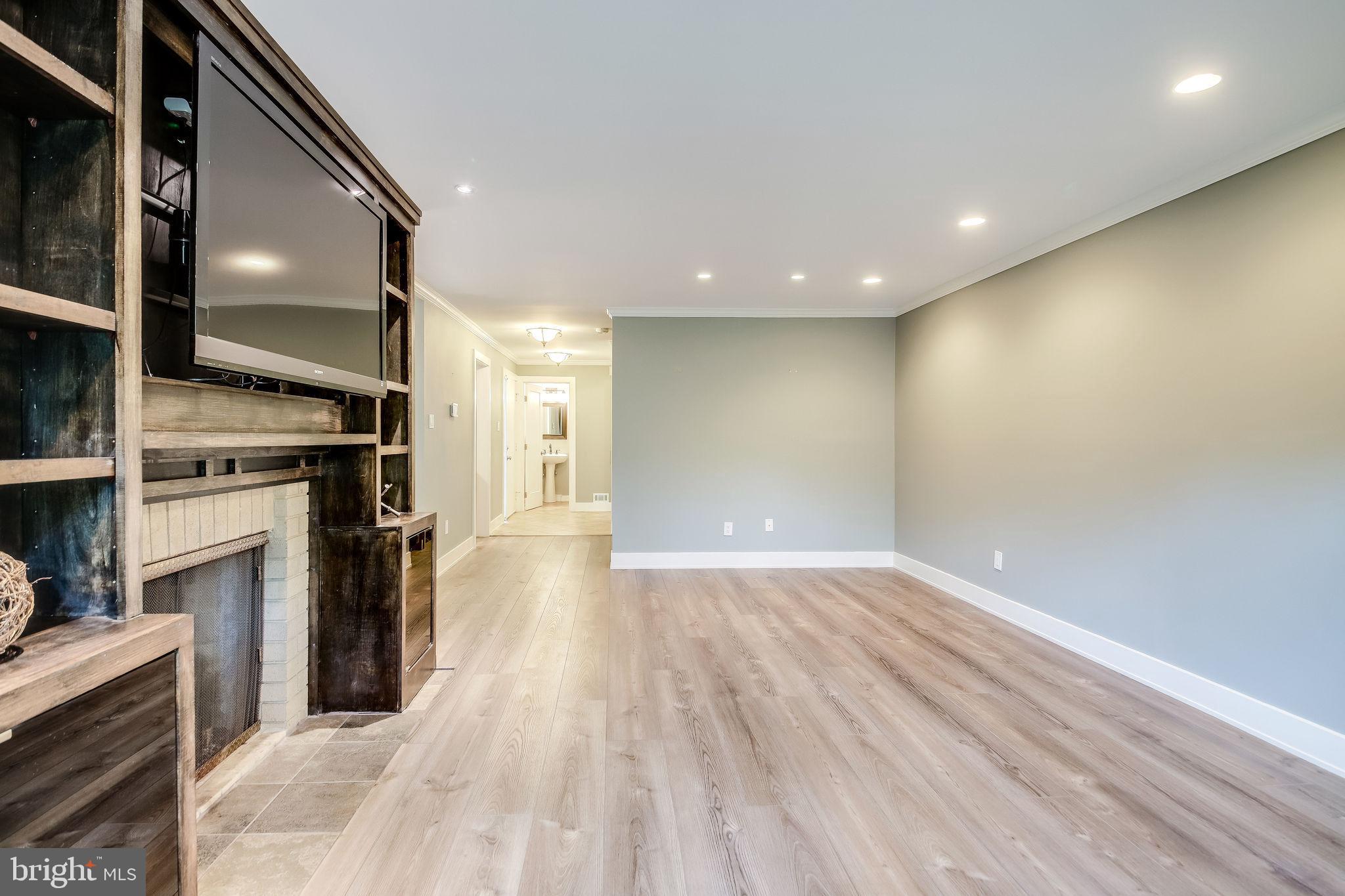 11629 Hunters Green Court Reston, VA 20191 - Photo 9 of 50 Living rm w/ wood burning FP and built-ins + TV