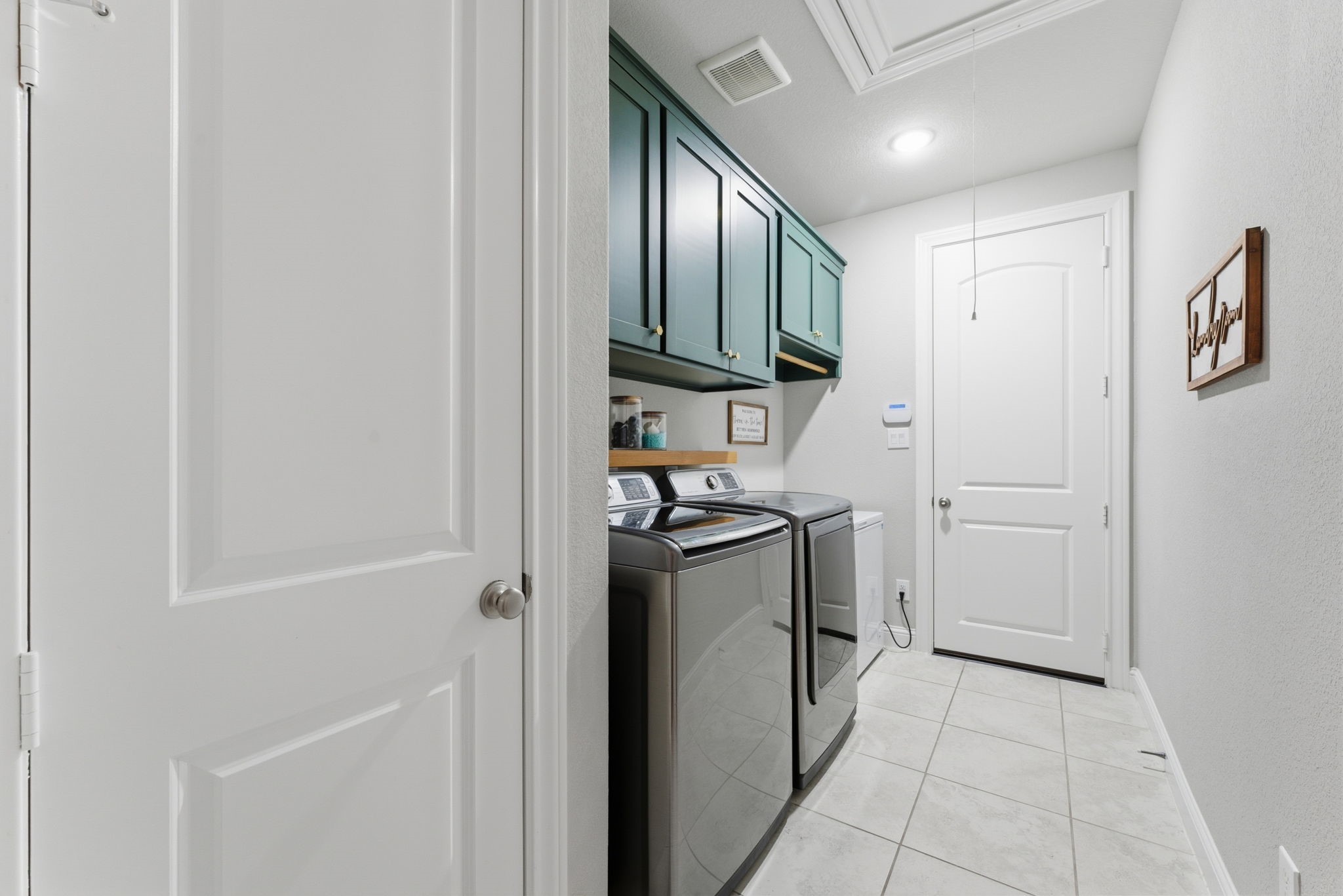 28117 Woodland Bend Way Spring, TX 77386 - Photo 12 of 48 Laundry room with closet and cabinets for storage.