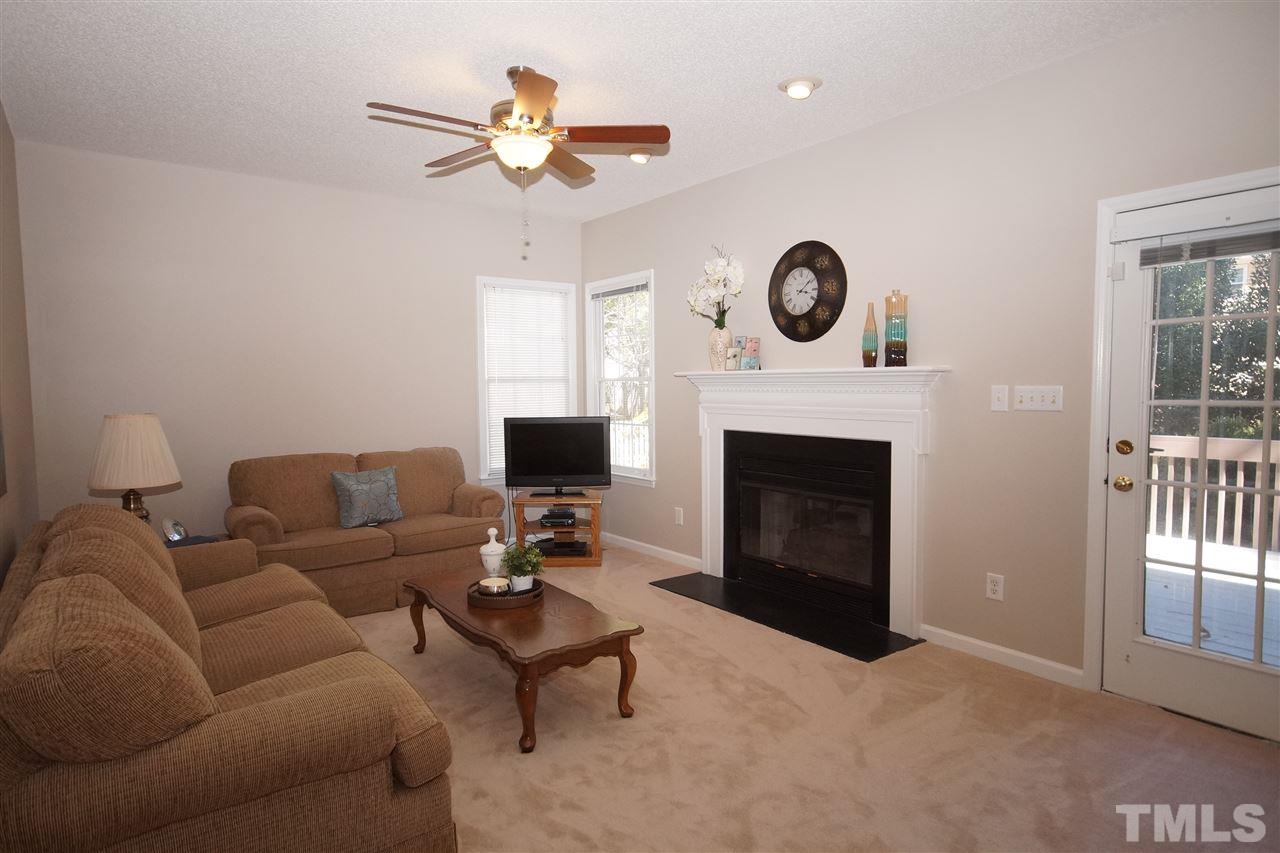 5249 Fairmead Circle Raleigh, NC 27613 - Photo 13 of 25 a living room with furniture a fireplace and a window