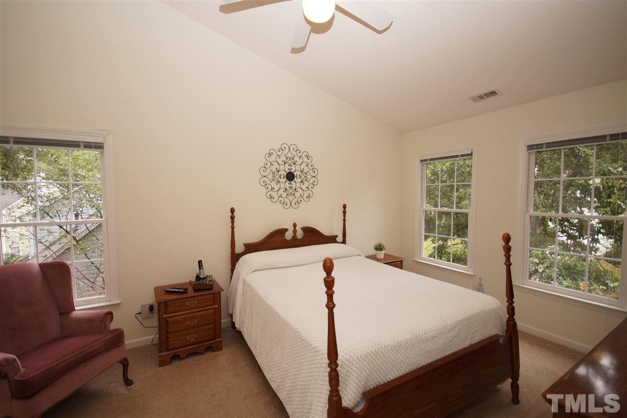 5249 Fairmead Circle Raleigh, NC 27613 - Photo 14 of 25 a bed sitting in a bedroom next to a window