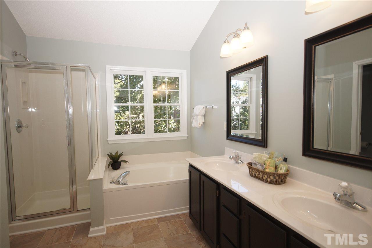 5249 Fairmead Circle Raleigh, NC 27613 - Photo 16 of 25 a bathroom with a tub double sink window and mirror