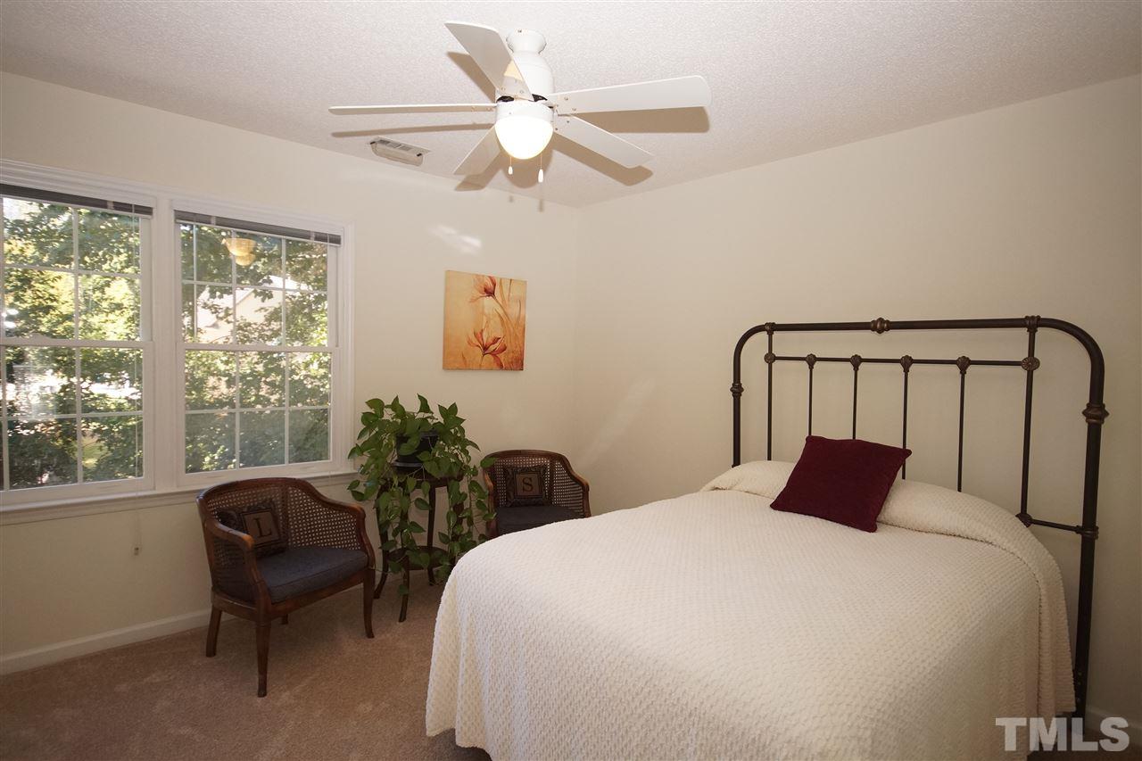 5249 Fairmead Circle Raleigh, NC 27613 - Photo 17 of 25 a bedroom with a large bed and a chair