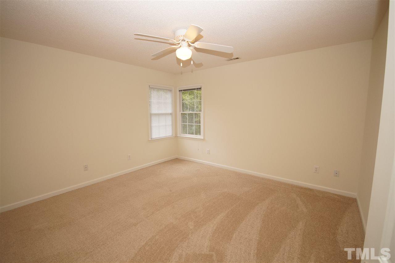 5249 Fairmead Circle Raleigh, NC 27613 - Photo 19 of 25 an empty room with windows and fan