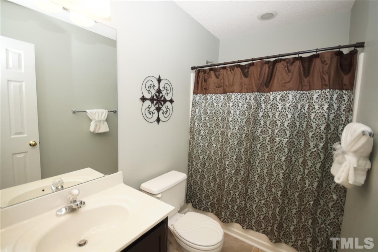 5249 Fairmead Circle Raleigh, NC 27613 - Photo 21 of 25 a bathroom with a sink and mirror with toilet