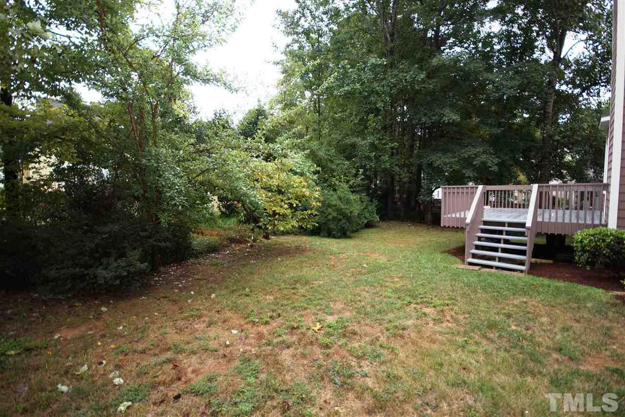 5249 Fairmead Circle Raleigh, NC 27613 - Photo 23 of 25 a backyard of a house with lots of green space and wooden fence