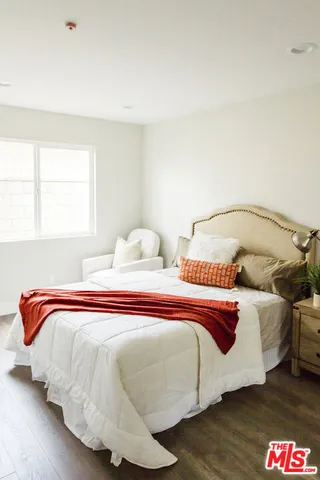 a bedroom with bed and a window