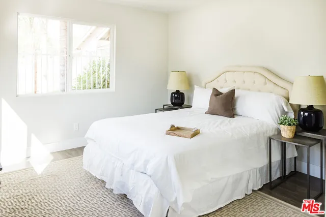 a bedroom with a bed and a table