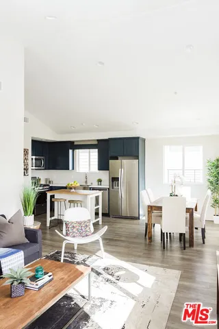 a kitchen with stainless steel appliances a stove a sink and a refrigerator