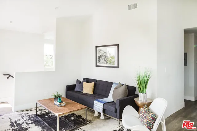 a bedroom with a bed and a night stand