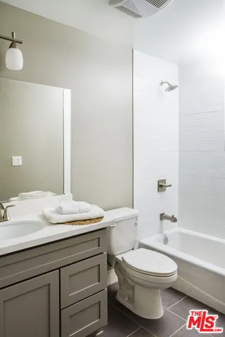 a bathroom with a sink a toilet and a bathtub