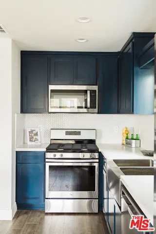 a kitchen with a table chairs cabinets and window
