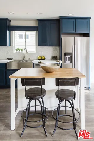 a view of a dining room with furniture a rug and wooden floor