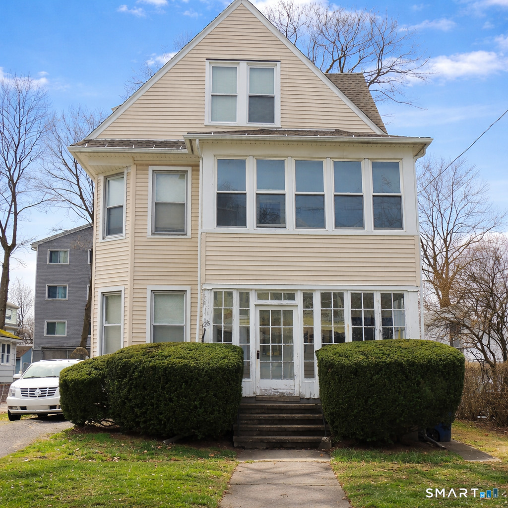 a front view of a house with a garden