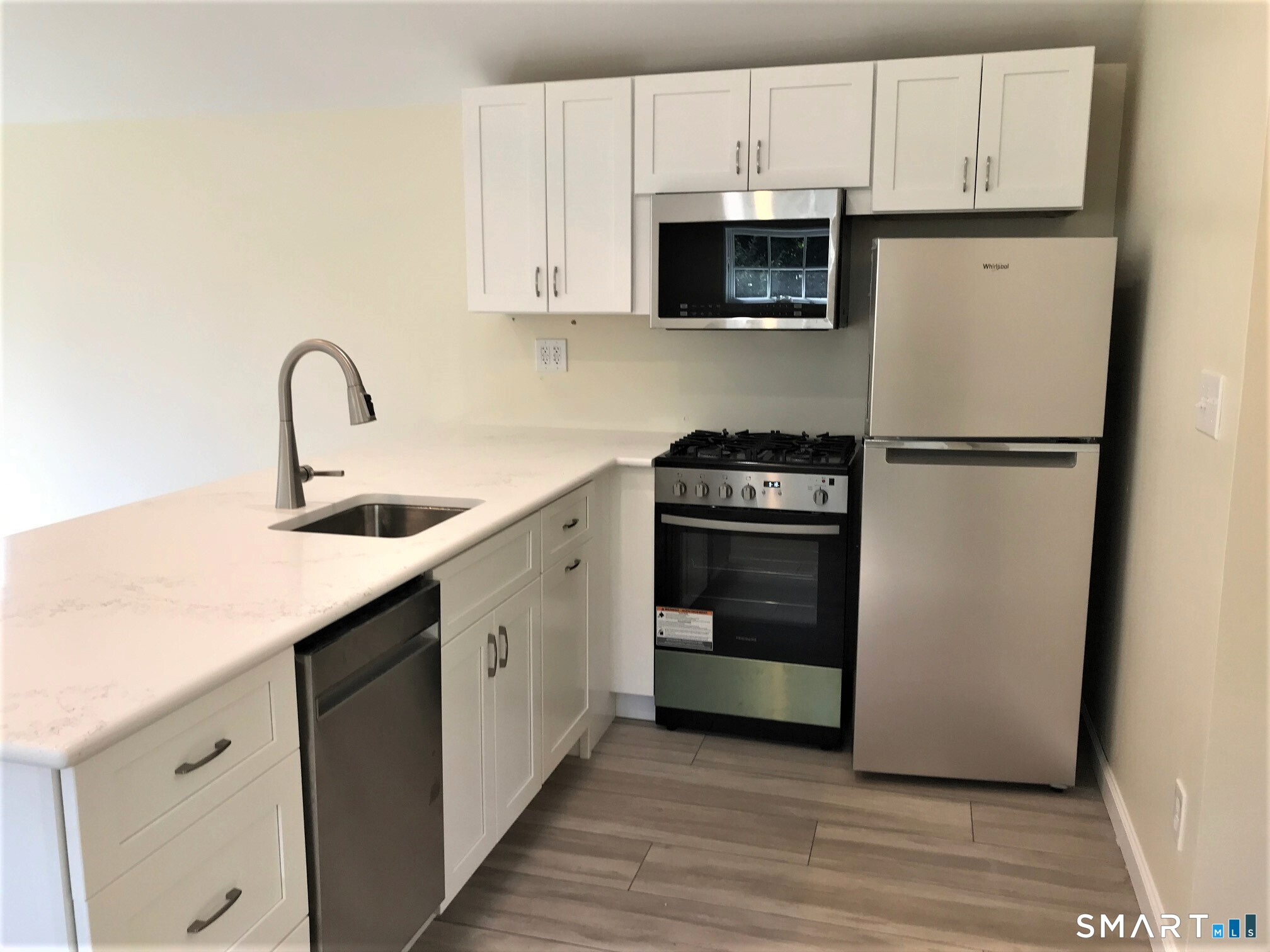 3509 Redding Road Fairfield, CT 06824 - Photo 16 of 27 a kitchen with a refrigerator and a sink