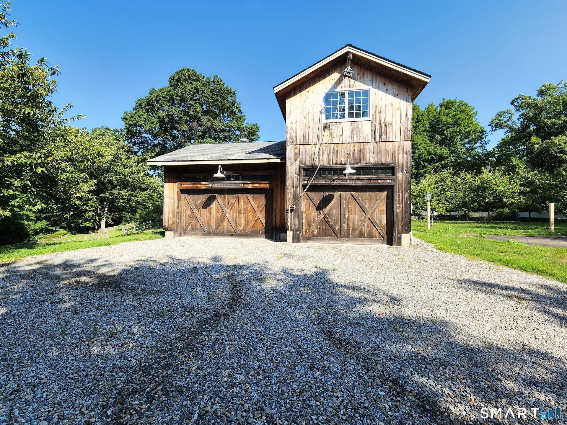 3509 Redding Road Fairfield, CT 06824 - Photo 2 of 27 a front view of a house with a yard and garage