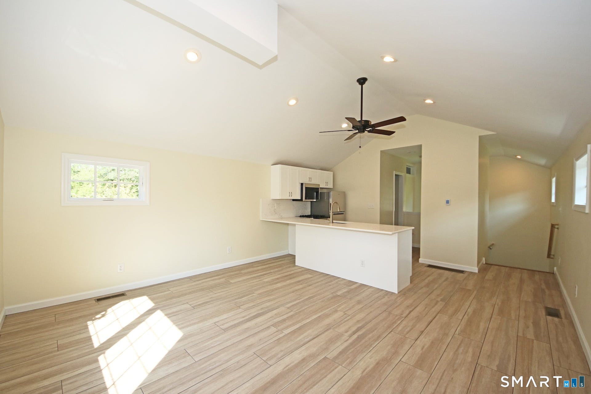 3509 Redding Road Fairfield, CT 06824 - Photo 21 of 27 a view of a kitchen with wooden floor and a ceiling fan
