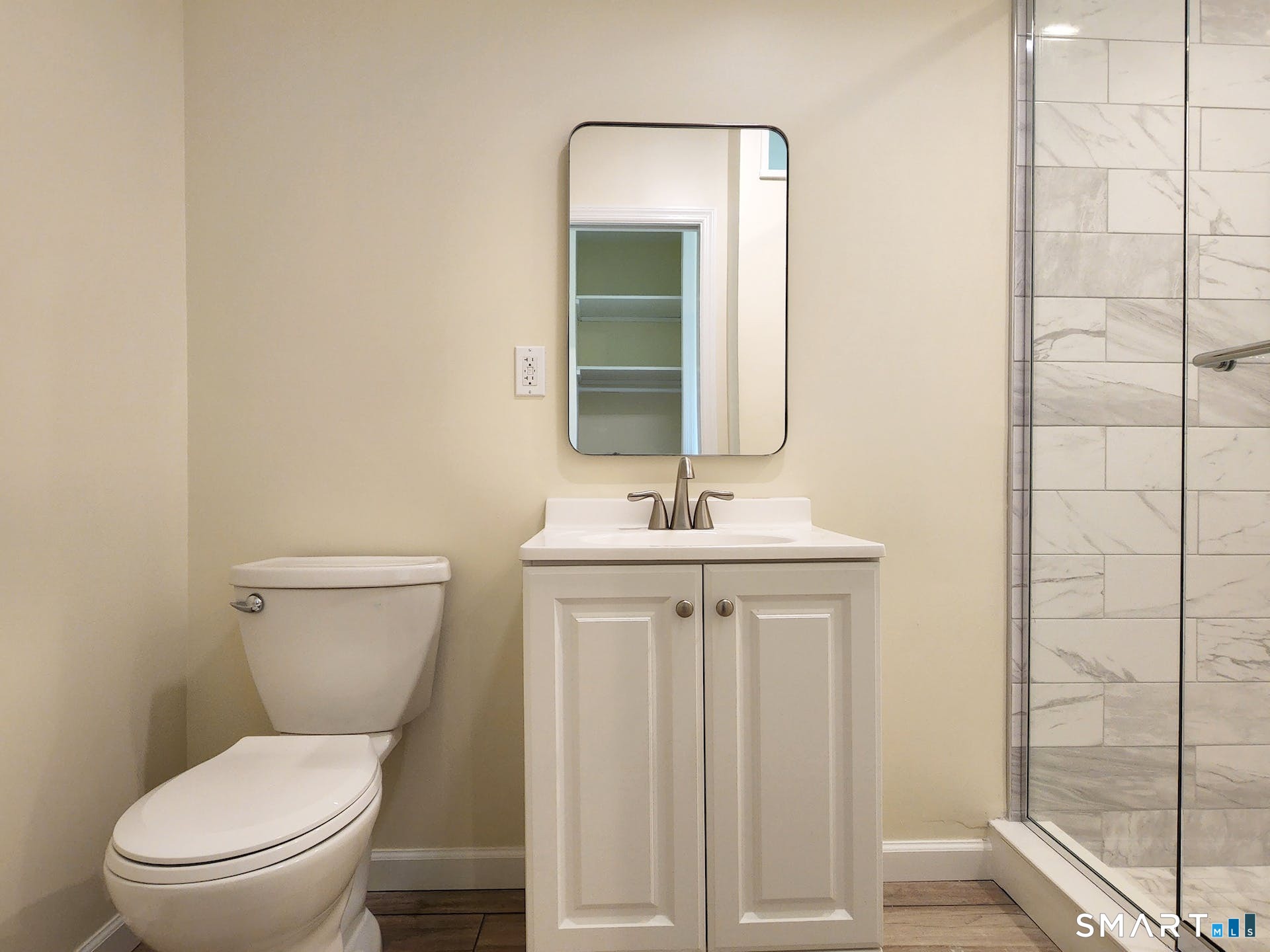 3509 Redding Road Fairfield, CT 06824 - Photo 22 of 27 a bathroom with a toilet a sink and mirror