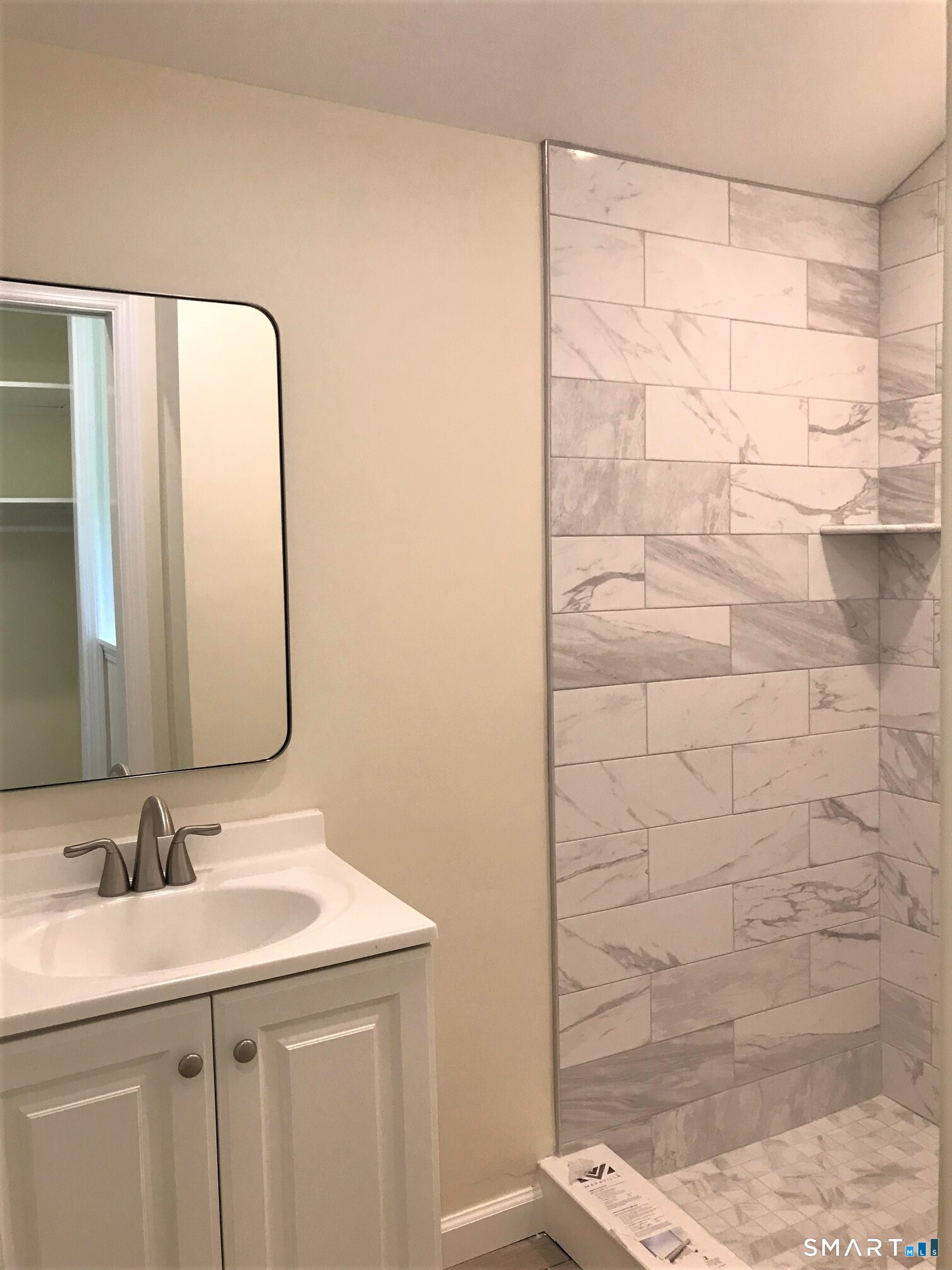 3509 Redding Road Fairfield, CT 06824 - Photo 23 of 27 a bathroom with a sink and a mirror
