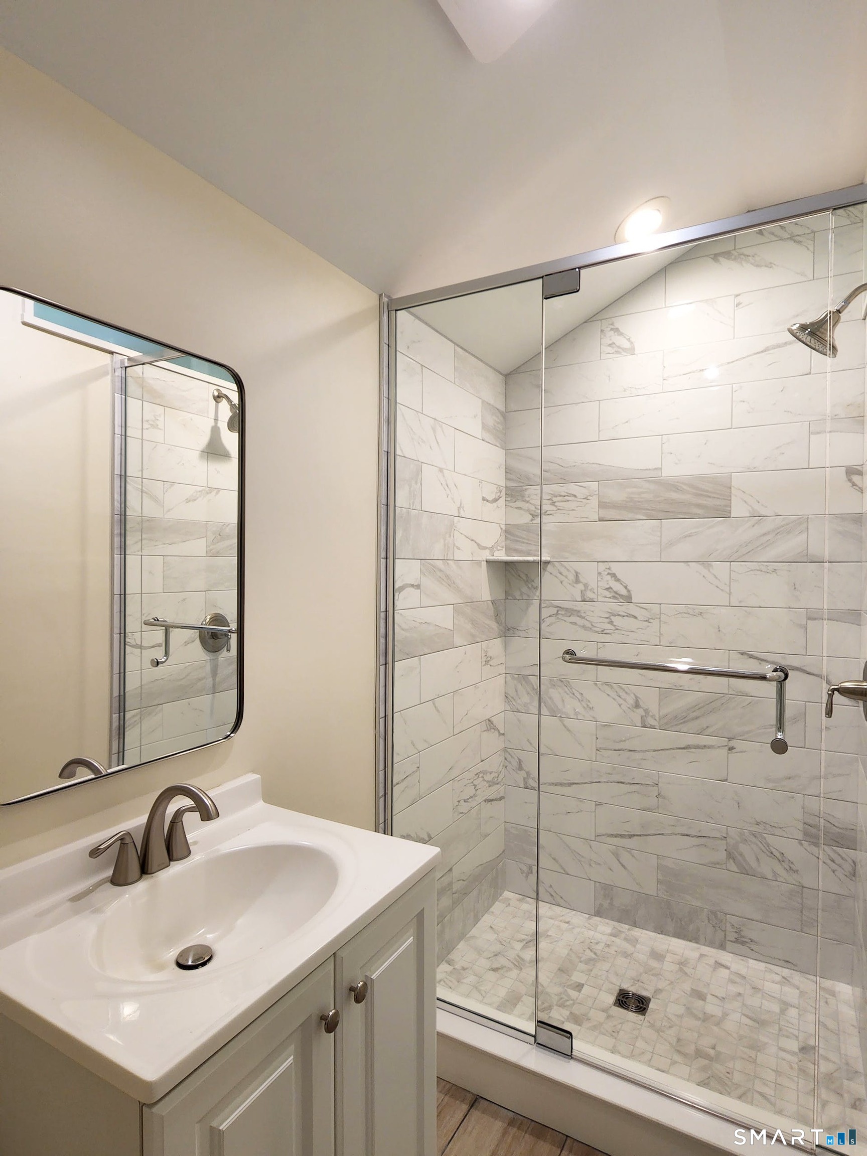 3509 Redding Road Fairfield, CT 06824 - Photo 24 of 27 a bathroom with a shower sink and mirror