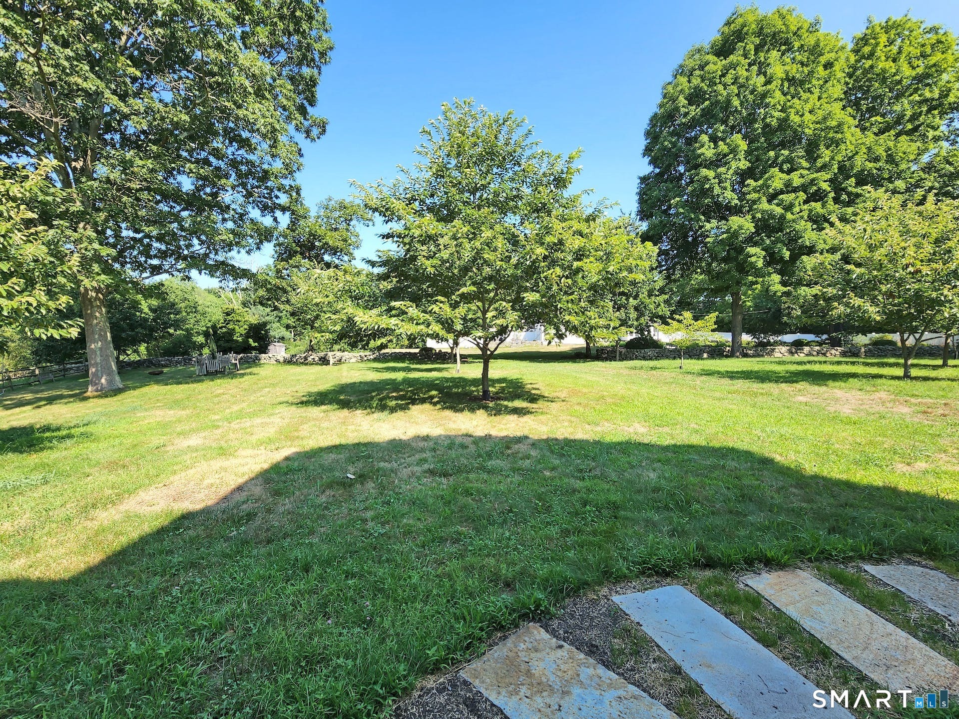 3509 Redding Road Fairfield, CT 06824 - Photo 8 of 27 a view of a garden with a bench