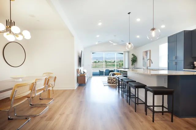 an open kitchen with dining table and chairs