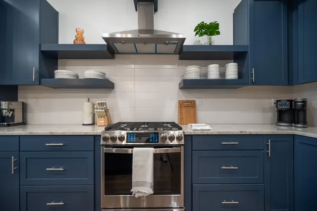 a kitchen with stainless steel appliances granite countertop a stove and a cabinets