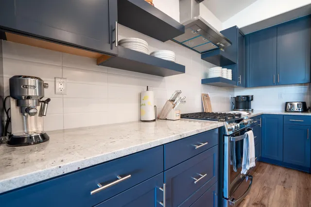 a kitchen with stainless steel appliances granite countertop a sink and wooden cabinets