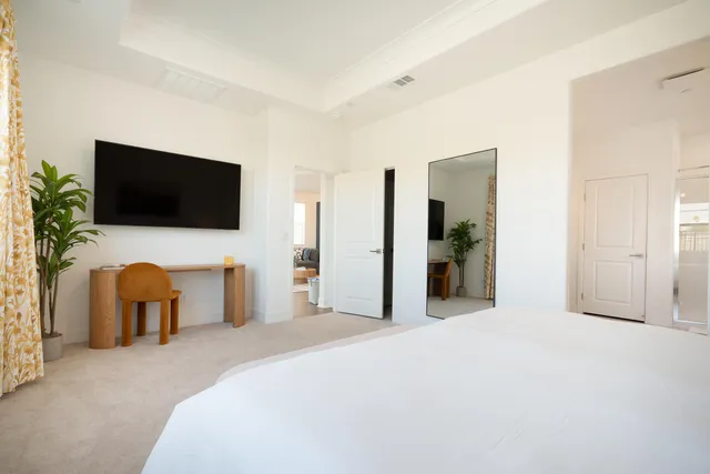a bedroom with a bed and a flat screen tv