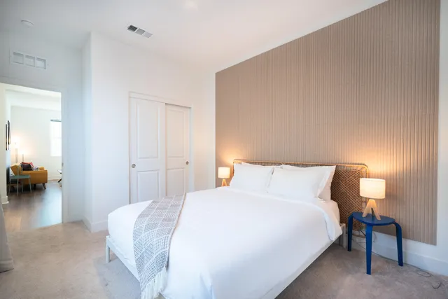 a bedroom with a bed and a couch