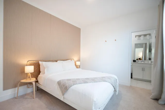 a bedroom with a bed and table