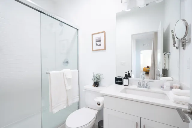 a bathroom with a sink toilet and shower