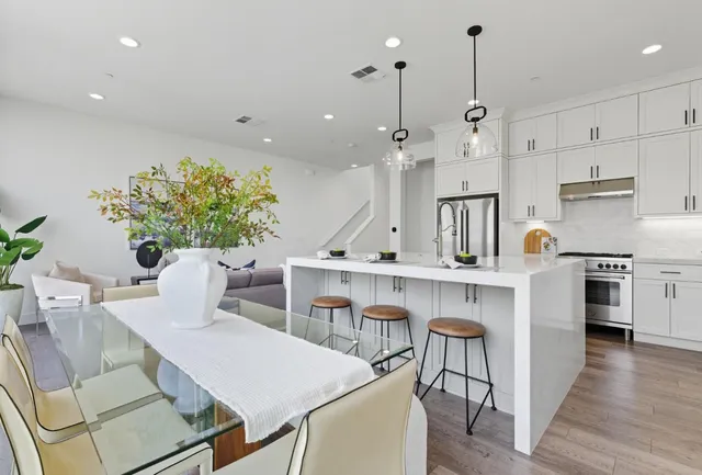 a view of kitchen with cabinets table and chairs