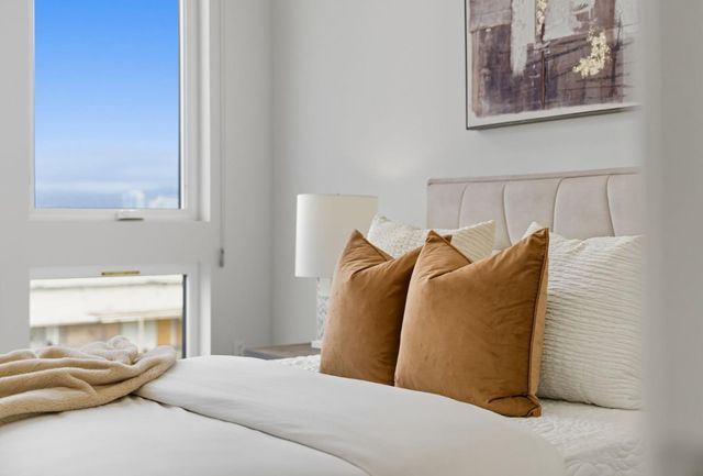 a bedroom with a bed and a window