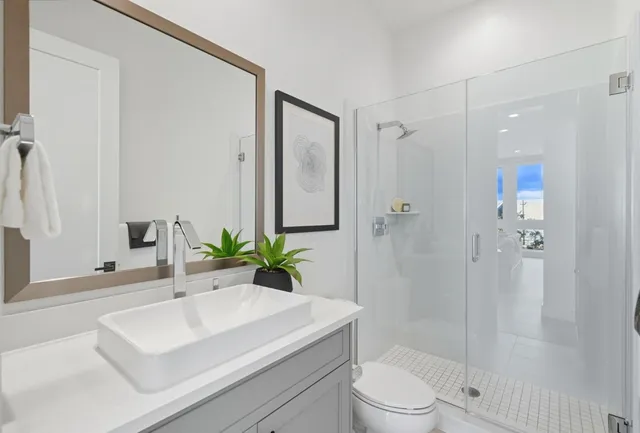 a bedroom with a bed a mirror and a table