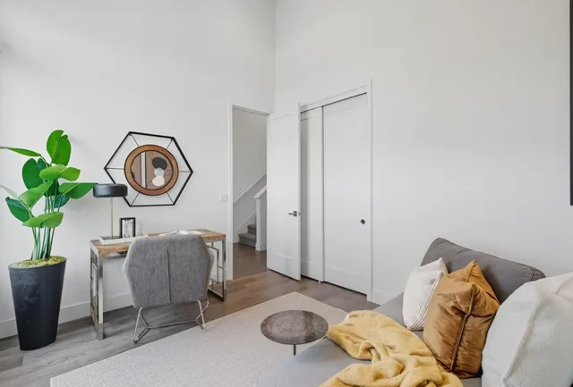 a living room with furniture and a clock