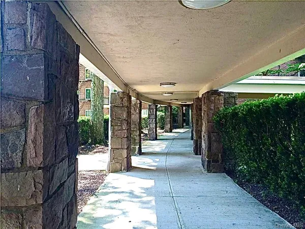 a view of a patio with table and chairs potted plants with floor to ceiling window