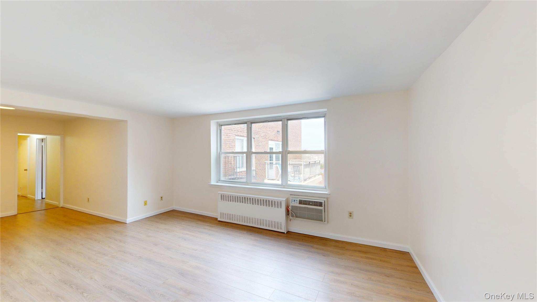 30 South Cole Avenue, Unit 6L Spring Valley, NY 10977 - Photo 4 of 13 an empty room with wooden floor and windows