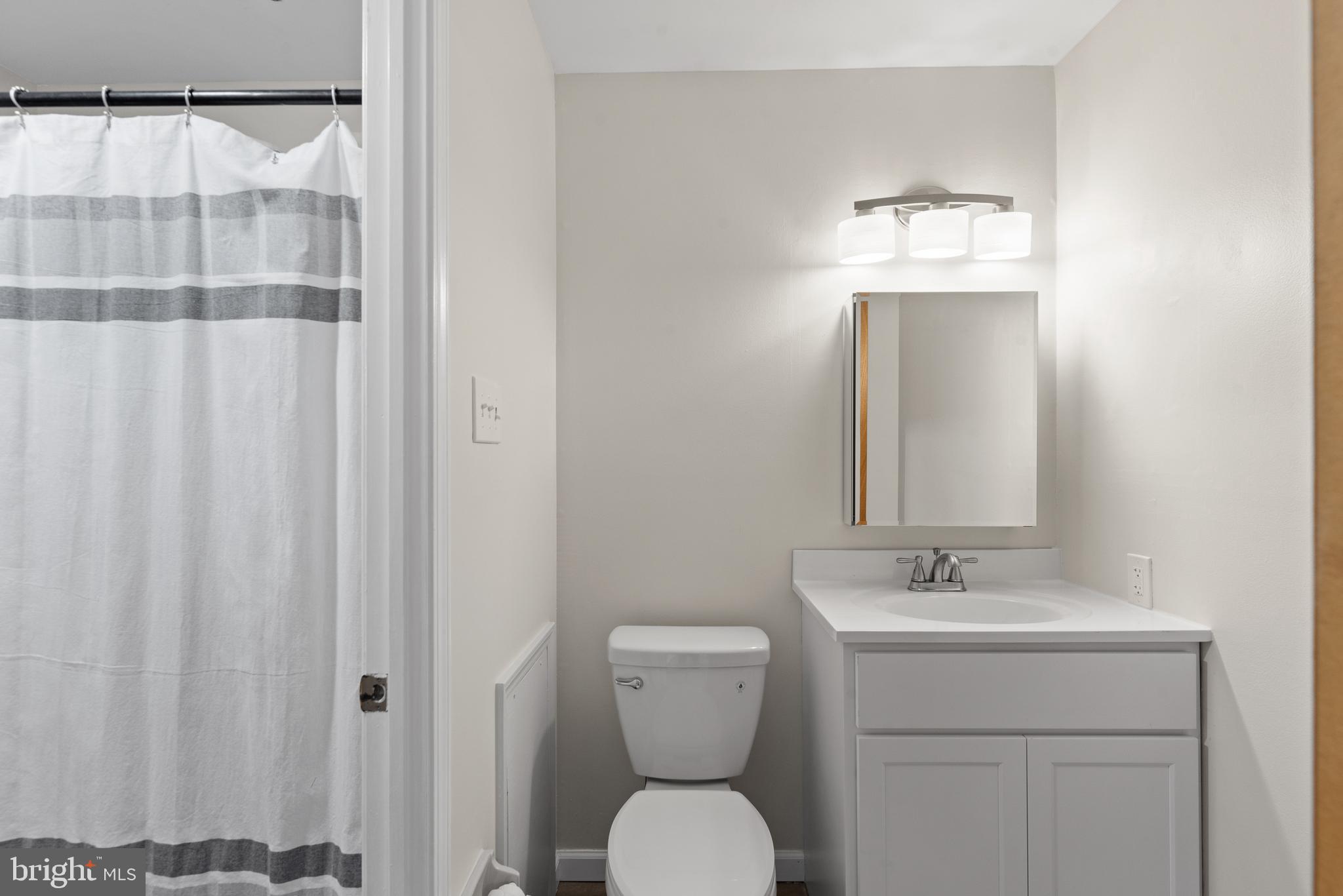 1101 Brinton Place Road, Unit 9 West Chester, PA 19380 - Photo 17 of 26 a bathroom with a toilet a sink and mirror