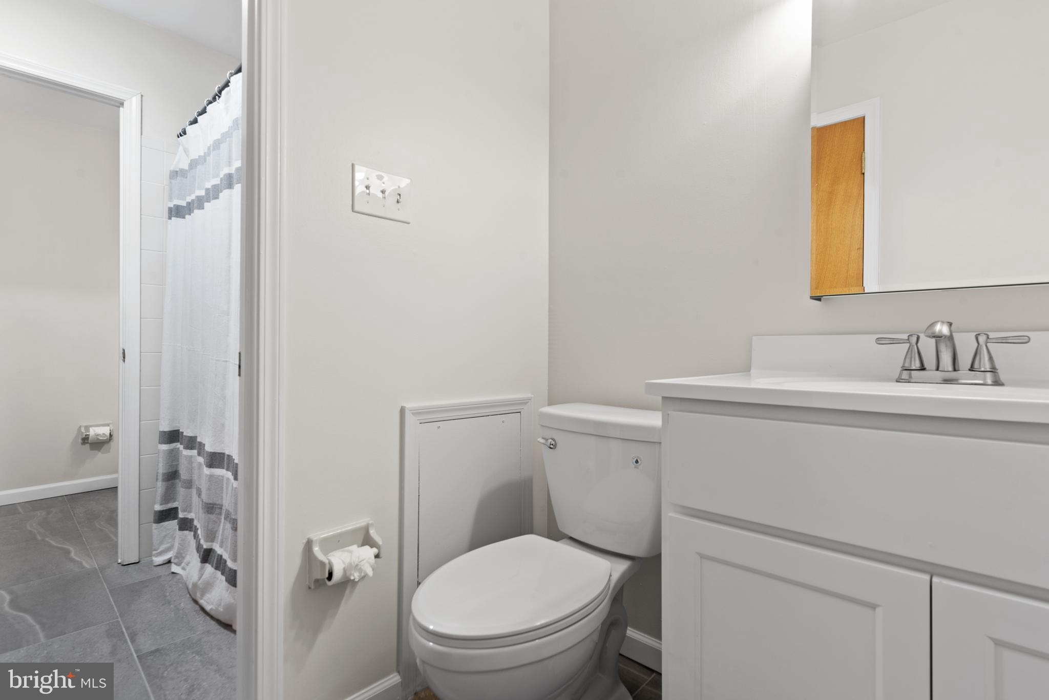 1101 Brinton Place Road, Unit 9 West Chester, PA 19380 - Photo 18 of 26 a bathroom with a toilet sink vanity and mirror