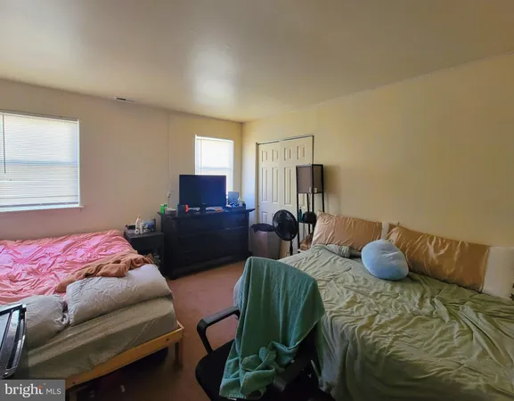 a bedroom with a bed and chair