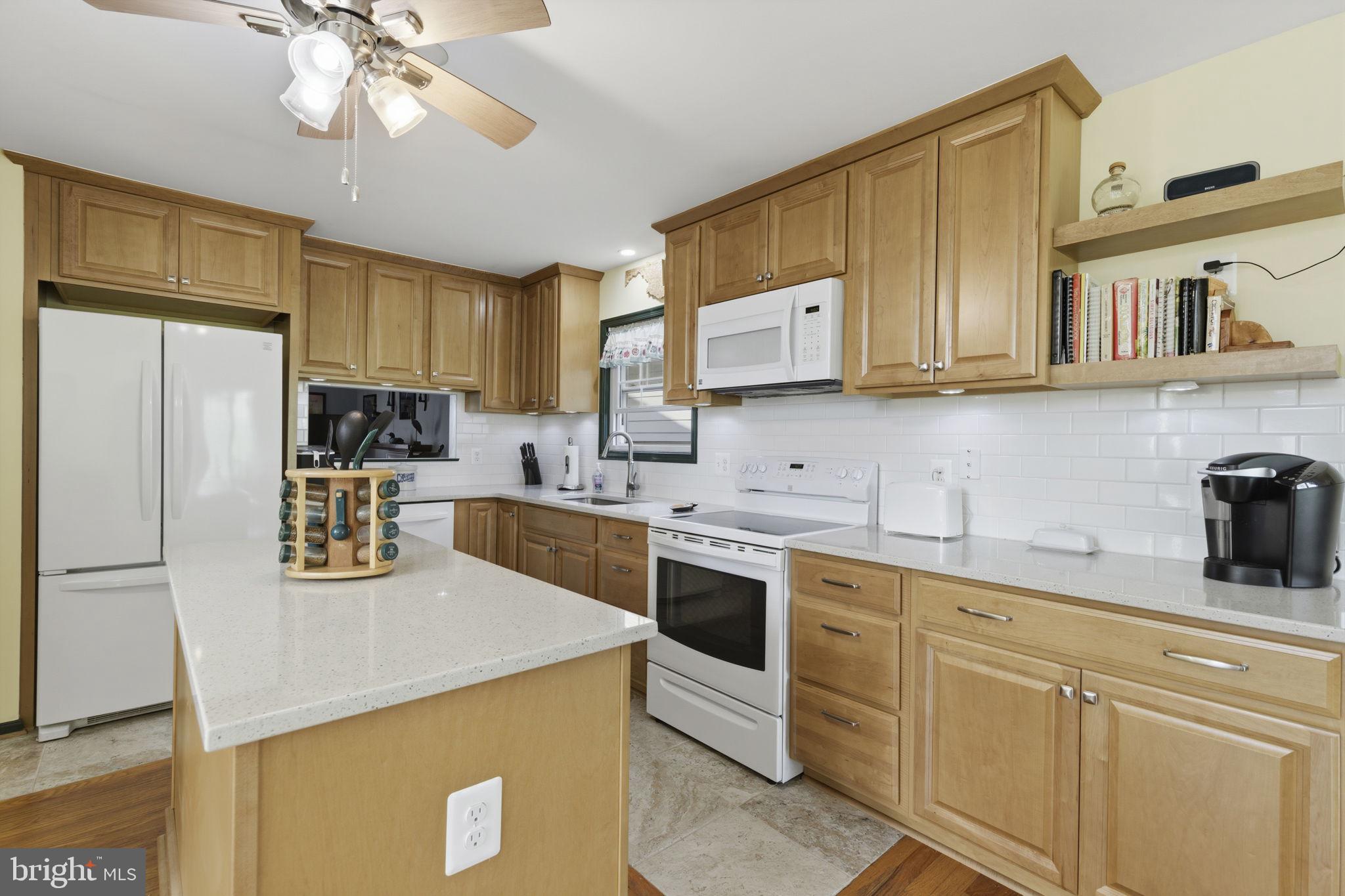 3831 Wilkinson Road Havre de Grace, MD 21078 - Photo 8 of 51 a kitchen with stainless steel appliances granite countertop a sink a stove a refrigerator cabinets and a window